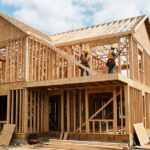 Wooden house under construction in framing stage